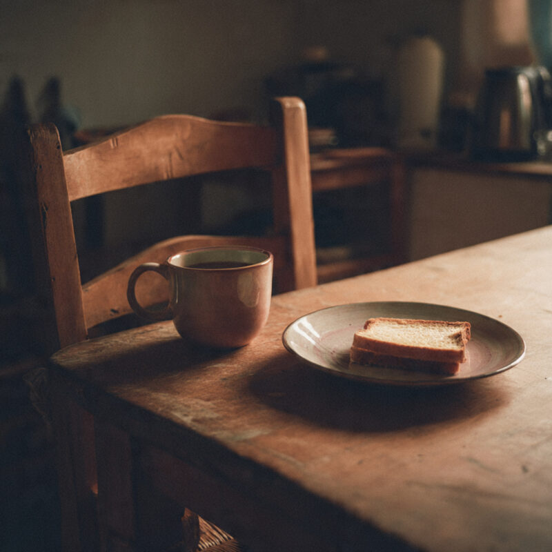 Empty chair at kitchen table with tea and toast the quiet emotional reality after weight loss