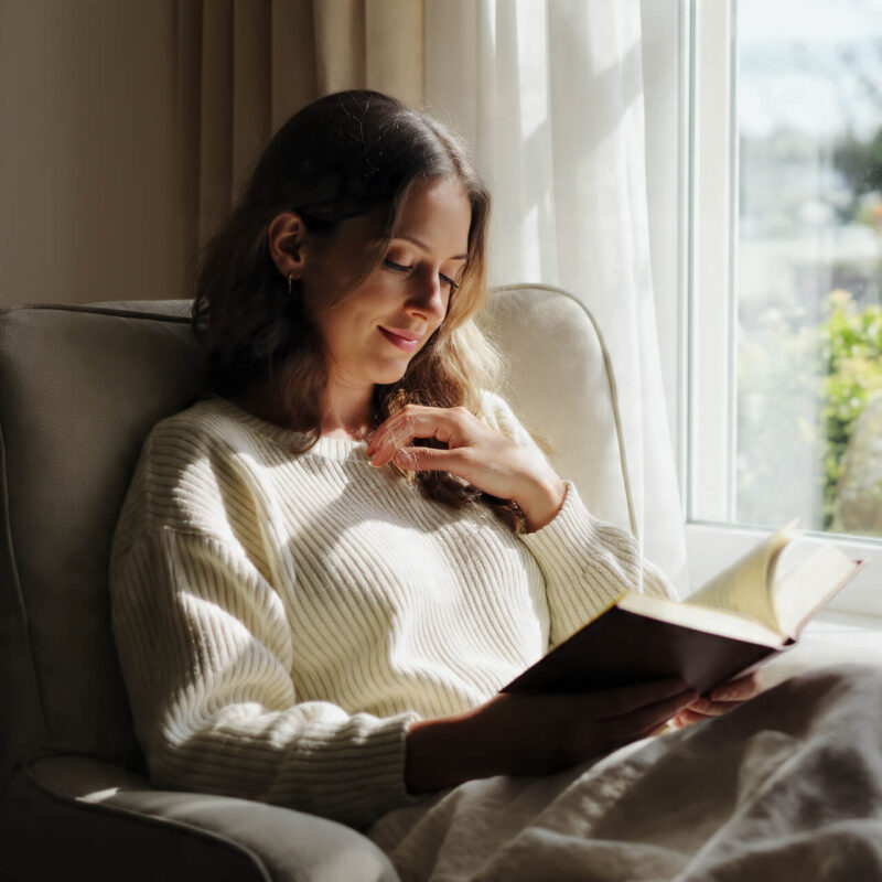 Person reading book with calm focus representing growth mindset and personal development