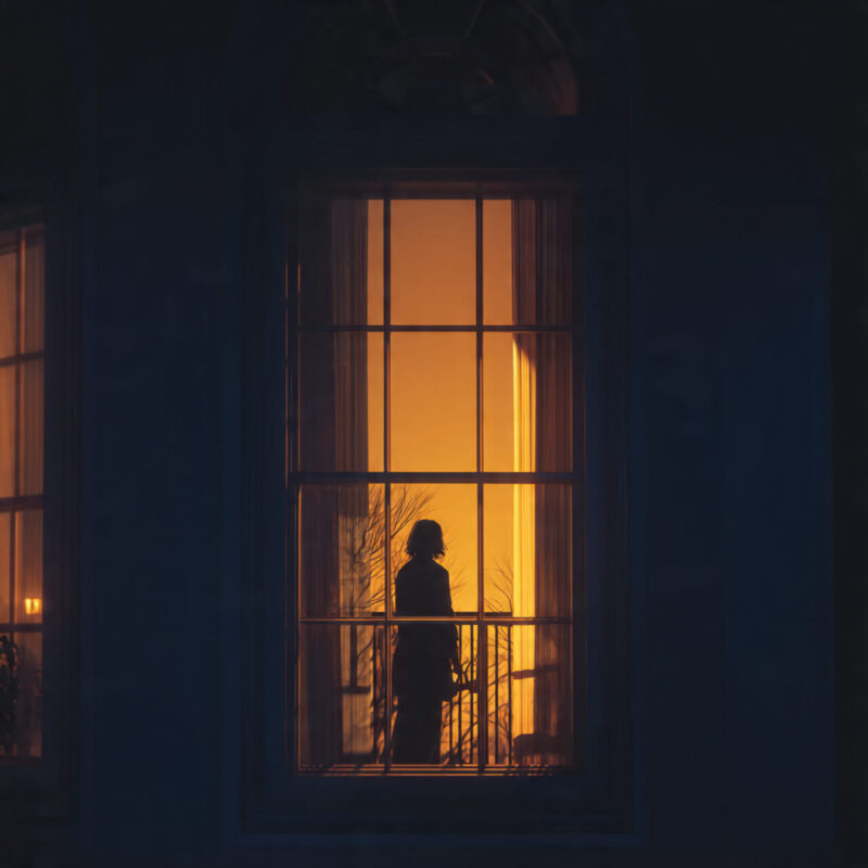 Woman standing at window at dusk contemplating change - representing the difference between laziness and burnout caused by old identity wiring